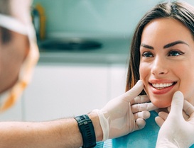 Cosmetic dentist in Arlington Heights looking at patient's smile