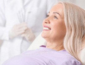 a patient smiling after receiving dentures in Arlington Heights