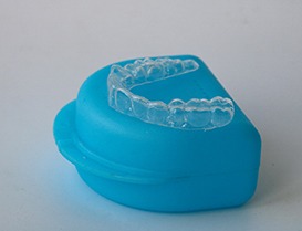Nightguard for bruxism on top of its storage case
