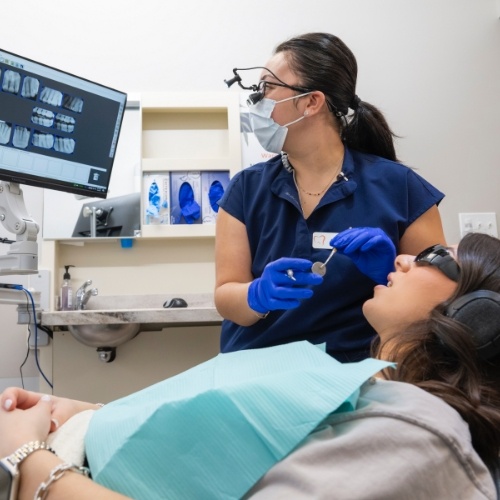 Dentist showing a patient x rays of their teeth