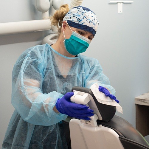 Dental team member cleaning patient chair