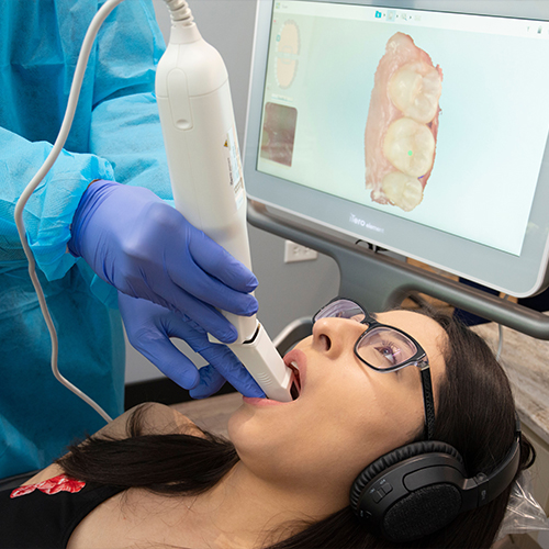 Dentist reviewing dental information on computer screen