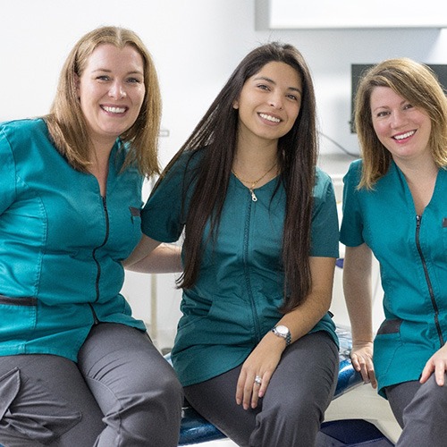 Dental receptionists smiling