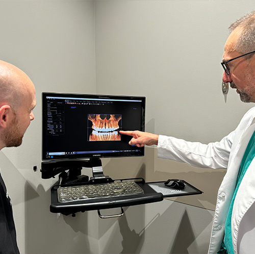 Man wearing polo giving thumbs up in dental chair