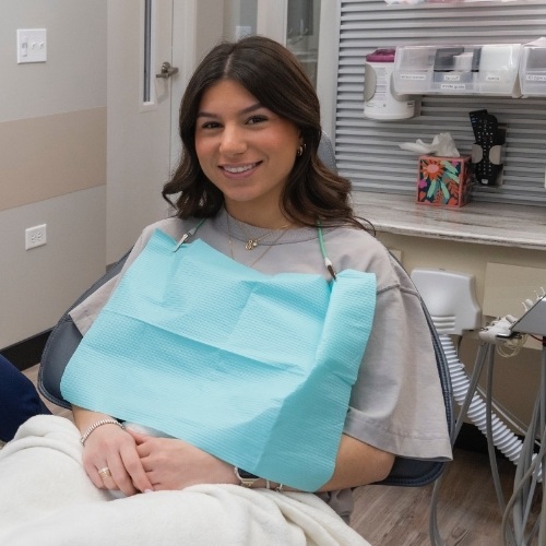 Young woman grinning in dental chair