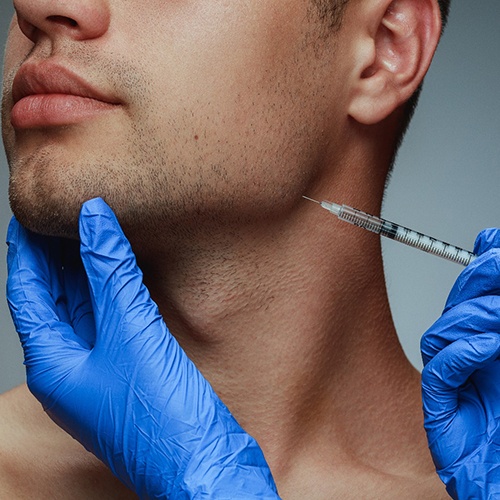 person receiving a Xeomin® injection in their jaw area