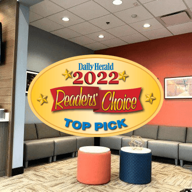 Daily Herald Readers Choice Top Pick badge over dental office waiting room in Arlington Heights