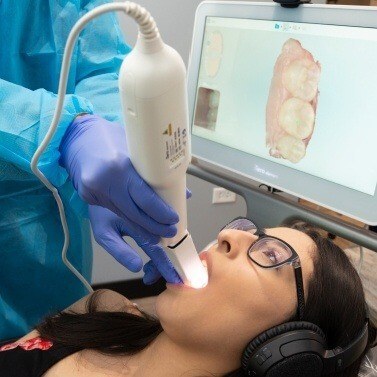 Dentist in Arlington Heights capturing digital images of a patient's mouth