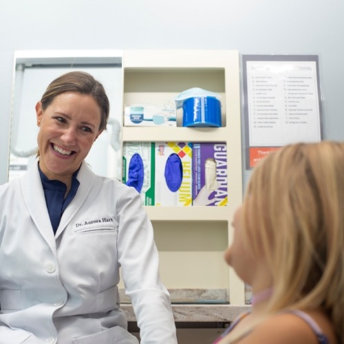 Dentist grinning at young patient