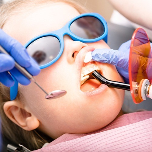 Child receiving dental sealants