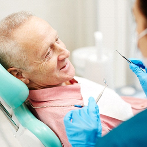 Man listening to dentist in Arlington Heights