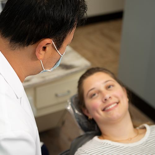 Woman smiling during a dental checkup in Arlington Heights