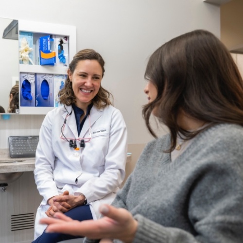 Woman in dental chair smiling with dental crowns in Arlington Heights 