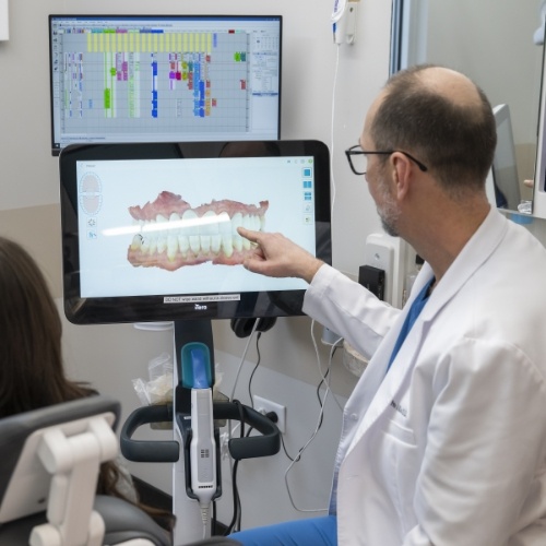 Dentist looking at digital models on screen of dental crowns in Arlington Heights