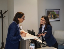 Dental team member showing a tablet to a patient