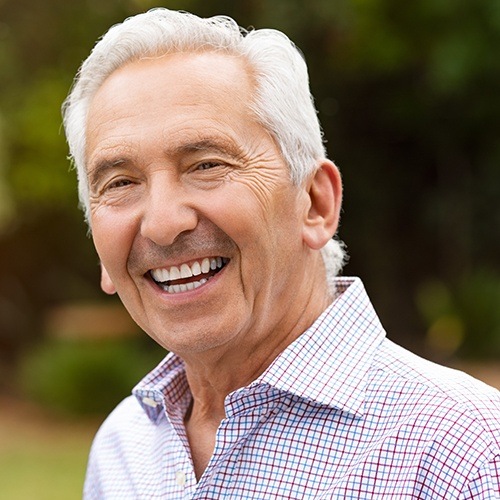 Older man with dentures sharing his healthy smile