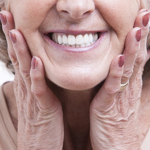 Close up of older woman smiling with dentures in Arlington Heights