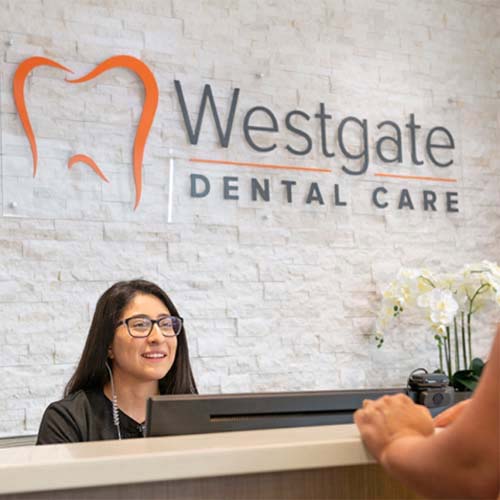 Receptionist and patient discussing the cost of dental emergencies in Arlington Heights