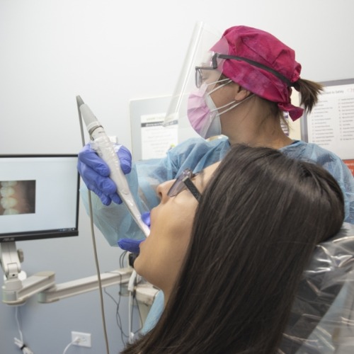 Dentist examining patient's smile during emergency dentistry treatment planning
