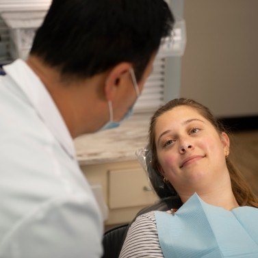 Dentist and dental patient talking in Arlington Heights