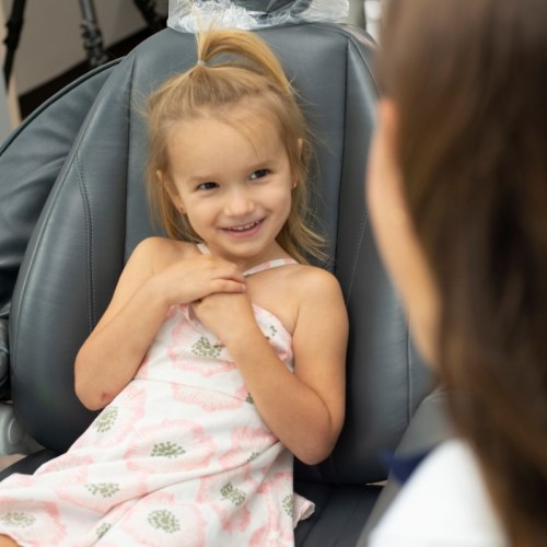 a child smiling after undergoing fluoride treatment