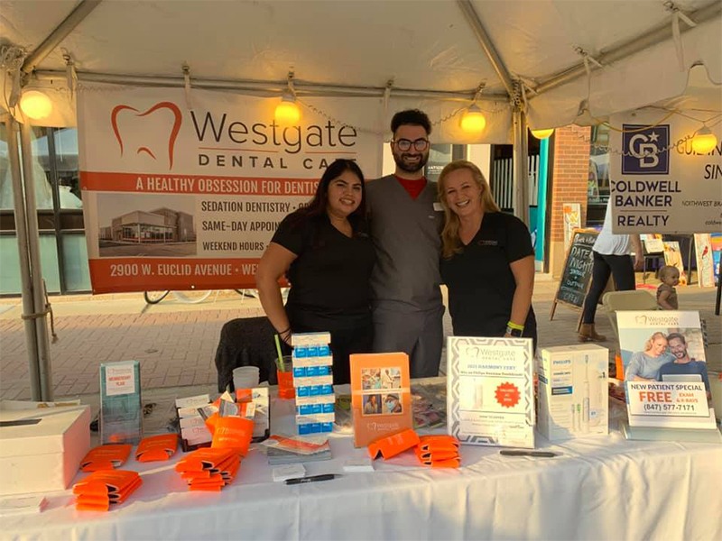 Arlington Heights dental team at table at outdoor event