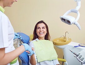 Dental patient shaking hands with her dentist