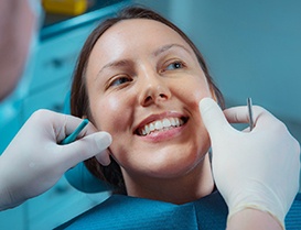 Woman smiling during her dental implant consultation