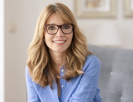 Woman with glasses and dental implants in Arlington Heights, IL smiling