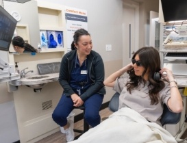 Young woman wearing sunglasses in dental chair