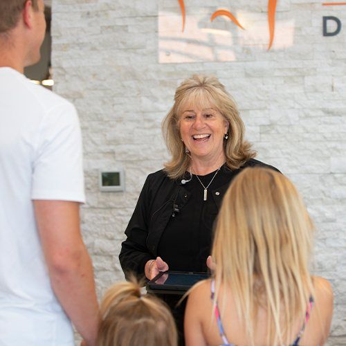 Family of three checking in at dental office front desk