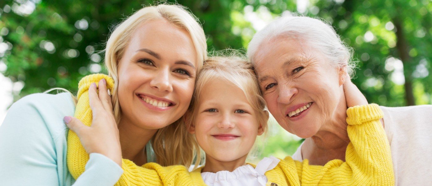 Three generations of women with healthy smiles after receiving dental services