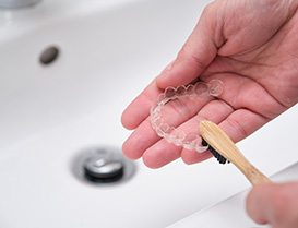 Dentist talking to male patient about Invisalign