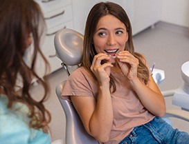Clear Invisalign aligner in a person’s hand