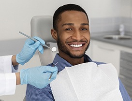 Man smiling in dental chair during his appointment with dentist
