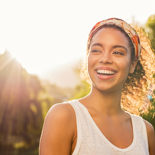 Young woman smiling with an even gumline 