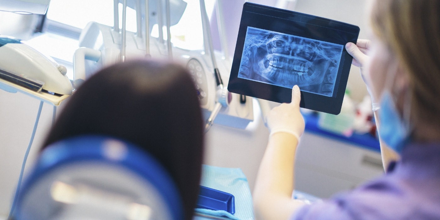 Dentist showing a patient an x ray of their teeth
