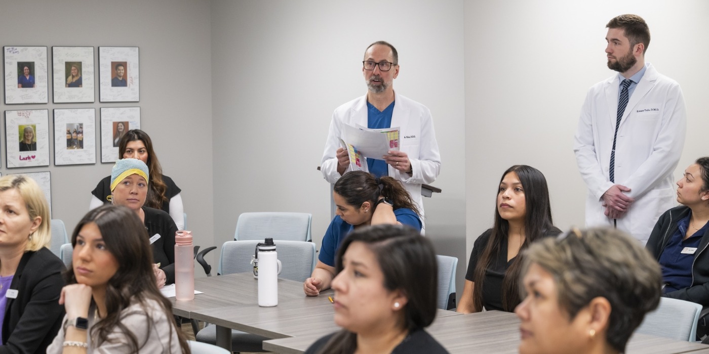 Doctor Kics watching a dental presentation