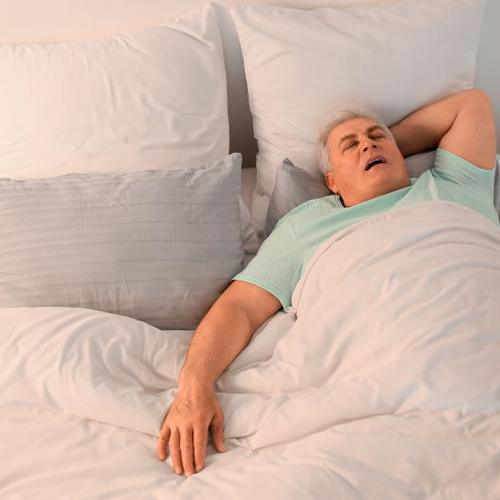 Senior man snoring in bed