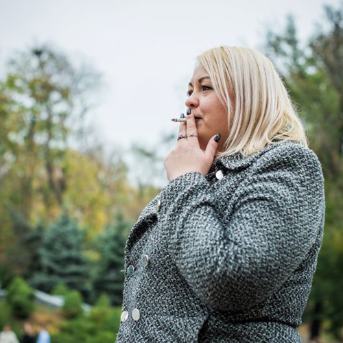 Plus size woman smoking a cigarette