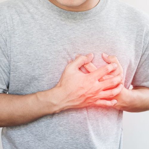 Man clutching his chest due to heart problems