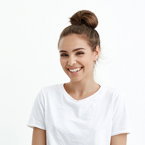 Woman in white t-shirt smiling without mouth cancer