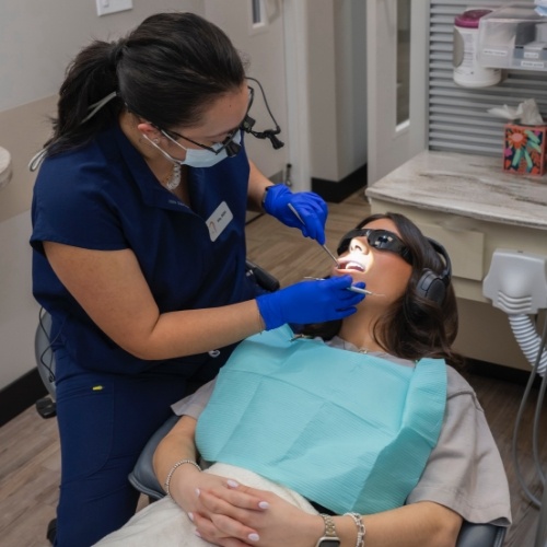 Woman having her mouth examined by dentist