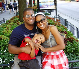 Doctor Christian sitting outside with his wife and son