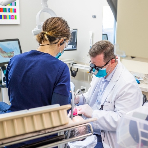 Dentist and assistant performing a fluoride treatment
