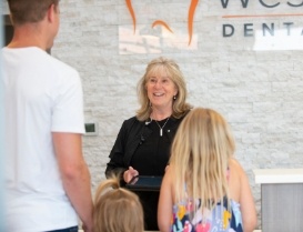 Family checking in at dental office front desk