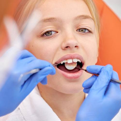 a child undergoing the process of getting dental sealants