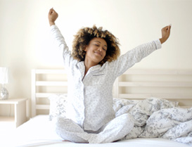 A woman waking up well rested 