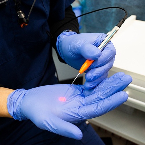 Dentist holding a of tissue dental laser