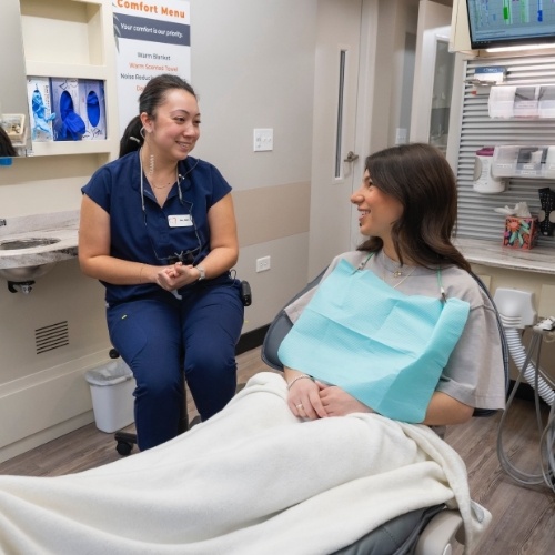 Dentist checking patient's tooth colored filling